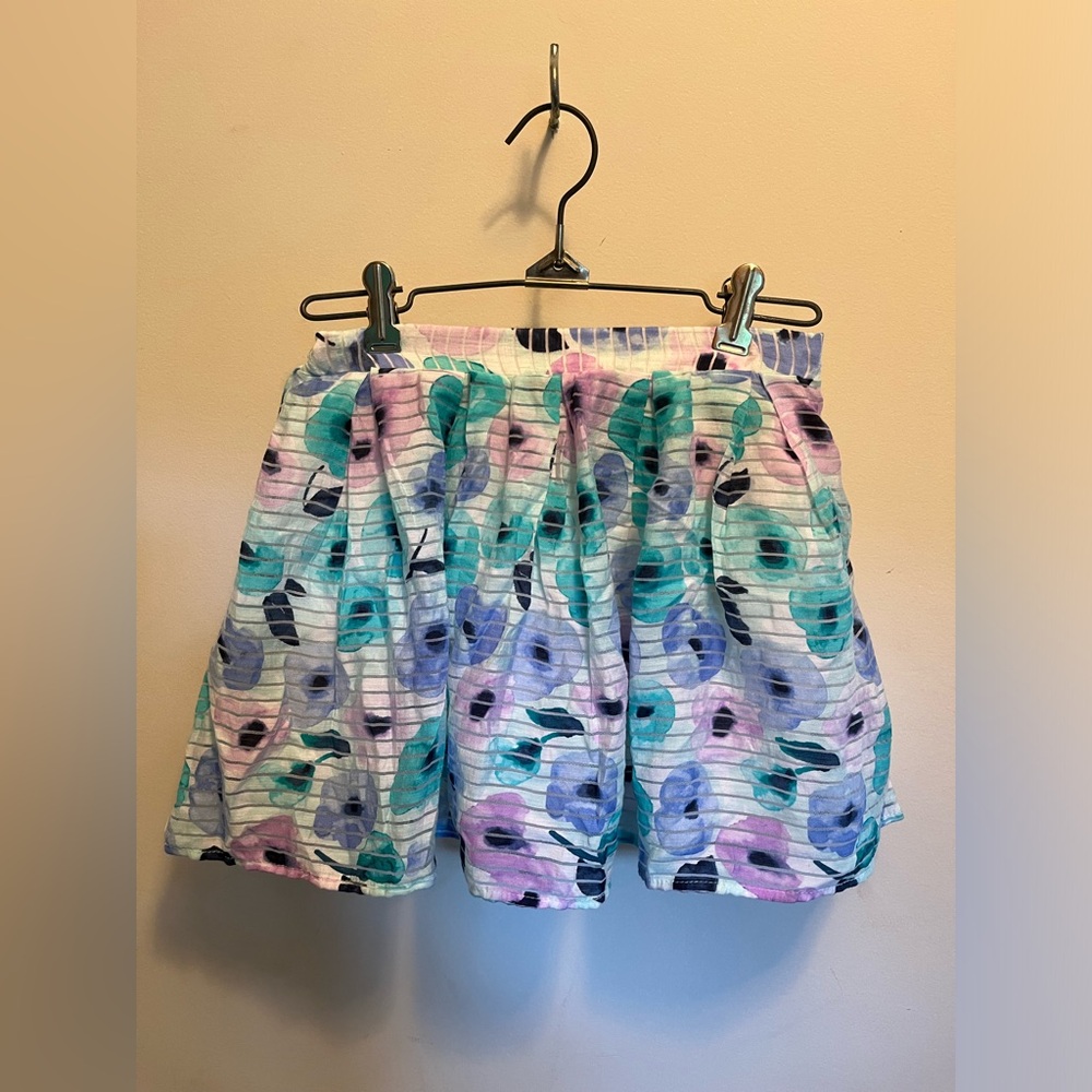 Cherokee, girls medium youth white ruffle skirt with floral pattern.